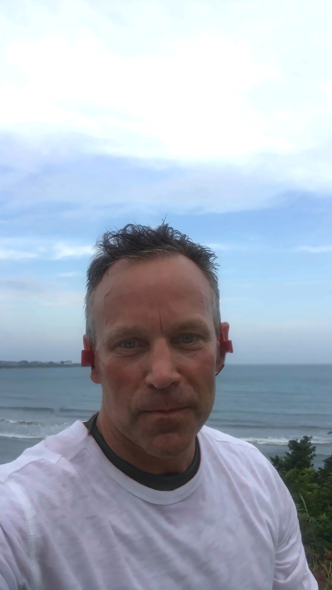 Paul Harkins standing above the ocean on an overcast morning